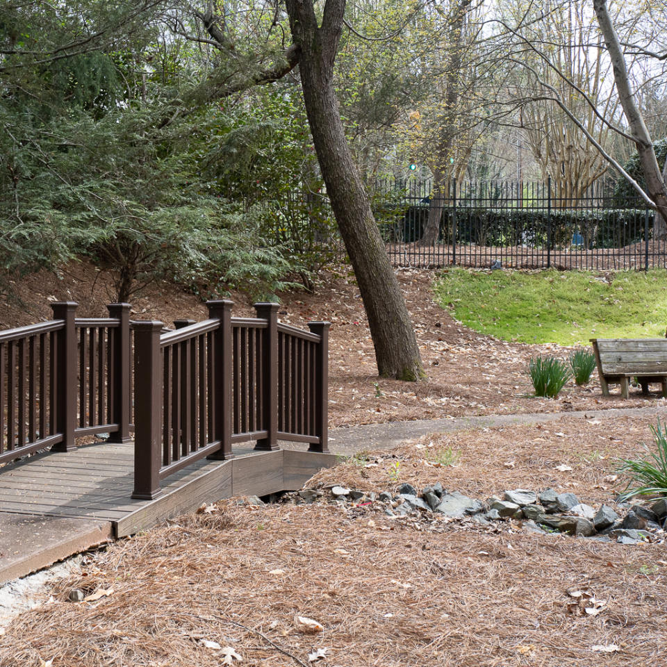 Park features including foot bridge and benches in a retirement community